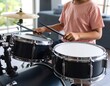 © sumur - Child drumming on a set of drums