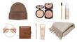 © aesthetic lovely - LIFESTYLE - Flat lay of brown winter accessories and beige makeup items including beanie, sunglasses, wallet, compact powder, brush, foundation, cream tube, and fringed scarf on white background