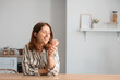 © Pixel-Shot - Young woman with mini fan in kitchen
