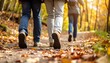 © Nashihal - Group of tourists walks along the path of the autumn forest. Feet close-up. Traveling in a small group.