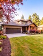 Garage door in luxury house with trees and nice landscape in Summer