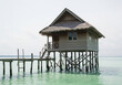 © tyt.production - Idyllic Beach Bungalow Serene Wooden Hut Over Turquoise Waters