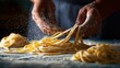 © Kant - Artisan pasta: Capturing the meticulous craft of fresh pasta, a skilled individual deftly shapes the strands, dusts them with flour, evoking the tradition of culinary art.