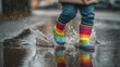 © Kant - Joyful Splash in the Rain: A child, adorned in colorful boots, leaps playfully into a puddle, capturing the pure essence of childhood bliss during a rainy day.