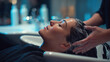 © Annamorphosis - Close-up of woman receiving a professional hair wash in a modern salon.