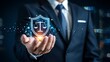 © Stocker - Businessman holding a glowing digital shield with scales of justice symbolizing legal protection and corporate security in a modern business environment
