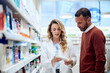© bnenin - Pharmacist Assisting Customer in Choosing a Product at a Pharmacy Store