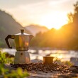 © De - Sunset view of coffee maker and cup beside river