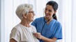 © Kage Dojo - A smiling nurse uses a stethoscope on an elderly patient, reflecting care and compassion in a healthcare setting.