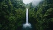 © 1389 - A stunning waterfall cascades through lush greenery, surrounded by dense vegetation and mist, creating a serene and picturesque natural scene.