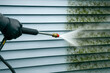 © Andrew - Pressure washer cleaning green mold from vinyl siding—clear before/after contrast. High-pressure water jet, home exterior maintenance, mildew and algae removal, power washing service.