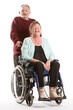 © track5 - Senior lady in a wheelchair. An elderly man pushes a laughing senior woman in a wheelchair, with a white background.