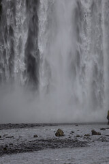 Canvas Print - skogafoss waterfall with rocks on the base.