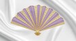 © Riyono - Elegance unveiled: A meticulously crafted ornamental fan on a silk backdrop portraying exquisite