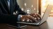 © Agus - A businessman types on a laptop, surrounded by digital banking and finance icons, with a smartphone nearby.