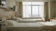 © Adobe Contributor - A modern hospital room features two beds, large windows with light curtains, and medical equipment, creating a clean, calm space for patients.