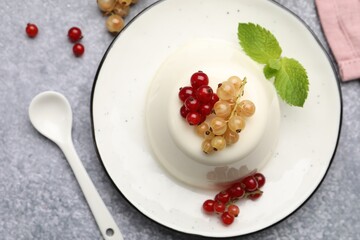 Wall Mural - tasty panna cotta with currants and mint on light grey table, flat lay