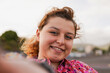 © Sabrina - Young curvy woman taking a selfie outdoor - Generation z, urban lifestyle and social media concept