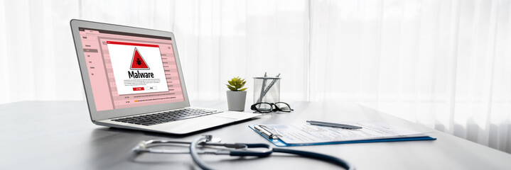 Cyber attacking concept. Malware alert showing on computer screen display scam and threat detection on computer system or online server to be removed brisk.