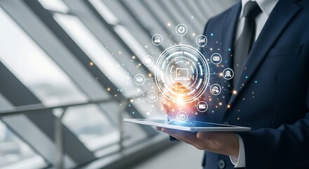 Businessman holding a tablet with a glowing digital network interface and icons representing various services