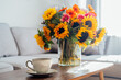 © okrasiuk - Focus on cup of hot drink and vase with huge sunflowers bouquet on wooden coffee table in modern cozy light living room with gray couch sofa. Cozy Design home decor. Summer mood, Relaxing rituals.