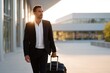 © Iryna - Young caucasian male in business suit walking with luggage at airport