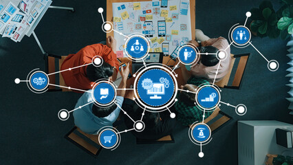 aerial view of professionals collaborating in a modern workspace, utilizing erp software solutions f
