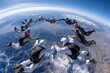 © YouraPechkin - Skydivers perform synchronized formation at high altitude over snow-capped mountains