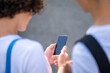 © zinkevych - Close up of two teens looking at the phone