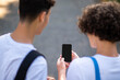 © zinkevych - Close up of two teens looking at the phone