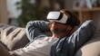 © Justlight - Relaxed individual in a VR headset reclining on a sofa with blurred background resting after experiencing dizziness from virtual reality use.