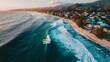 © irawan - Coastal town at sunrise with waves crashing on the shore.