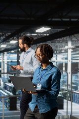 Data center programmer on industrial platform checking lines of code, collaborating on AI tasks. Server room IT specialist visualizing large language model architecture using computer.