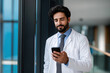 © Mselected - Medical professional checking smartphone in modern healthcare facility