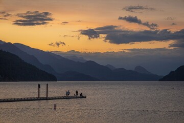 Wall Mural - serene sunset over lake and mountains