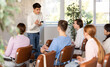 © JackF - Young man lecturer conducting lesson for group of interested adult students sitting on chairs in auditorium