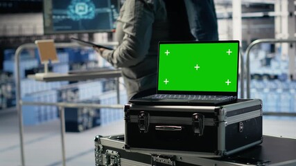 Close up of isolated screen laptop in front of data center programmers improving AI rigs processing speed. Server hub coworkers manage gear using chroma key device to support AI workloads, camera B