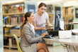 © JackF - Girl helps a female student find information on the internet using a computer in a university library