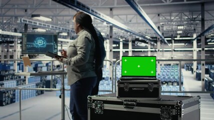 Close up of isolated screen laptop in front of data center programmers improving AI rigs processing speed. Server hub coworkers manage gear using chroma key device to support AI workloads, camera A