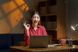 © amnaj - Happy young Asian businesswoman gesturing ok sign while working late using laptop computer at home office
