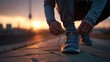 © lan - Young Adult Tying Running Shoes Before Evening Workout. High quality
