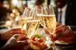 © oksa_studio - Business people celebrating success, making a toast with champagne glasses at a festive dinner party, close up shot focusing on the clinking glasses