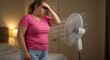 © aritha - Woman suffering from heat in bedroom