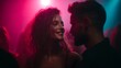 © Thares2020 - Friends dancing at a lively New Year party under vibrant colored lighting