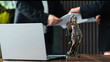 © Vladislav - Lawyer discussing case details with a client, while a statue of Lady Justice stands on the desk beside a laptop, symbolizing the pursuit of justice and legal representation