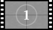 © NIHARIKA - Vintage film countdown timer showing the number one with film strip border movie cinema