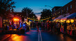 © ymimages - An evening street festival with a live music band on stage and crowds enjoying the event at dusk.