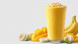 A vibrant mango banana smoothie is served in a tall glass, topped with coconut flakes and surrounded by ripe bananas and fresh mango chunks, making for a healthy treat