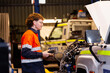 © Austockphoto - Aussie workman using digital diagnostics tool working on car vehicle engine in mechanics workshop