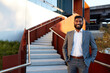 © Austockphoto - Indian businessman with open collar cheerful outdoors in city